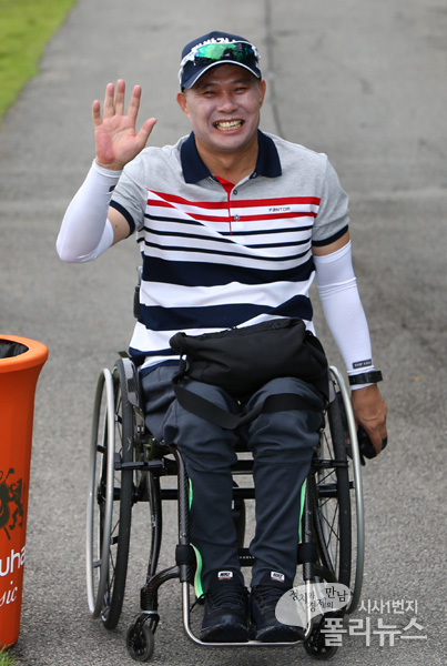 휠체어를 타고 경기장을 누비던 이정은 프로의 아버지 이정호씨가 딸의 우승에 손을 흔들며 기뻐하고 있다.