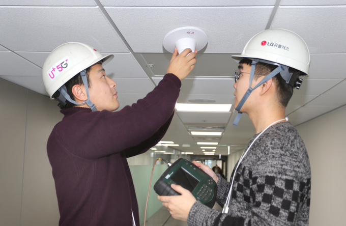 LG유플러스 직원들이 신축 건물에 5G 인빌딩 안테나를 설치하는 모습. <사진=LG유플러스 제공>
