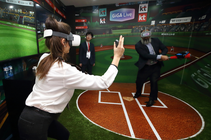 25일 MWC 2019에서 KT 부스를 방문한 관람객이 5G 플레이그라운드 존에서VR 야구게임을 즐기고 있다. <사진=KT 제공>