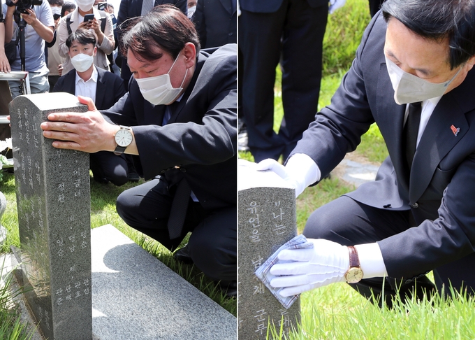 지난 19일 더불어민주당 김두관 의원이 앞서 윤석열 전 검찰총장이 만진 묘를 닦고 있다. <사진=연합뉴스>