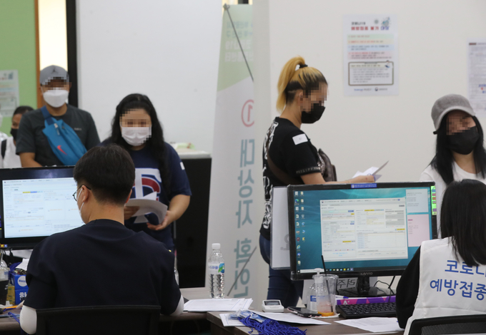  14일 오후 부산시민공원에 마련된 부산진구 코로나19 예방접종센터에서 외국인이 체온 검사를 받고 있다. (사진=연합)
