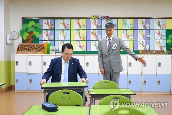 초등학교 교실 책상에 앉아보는 윤석열 대통령 [사진=연합뉴스]