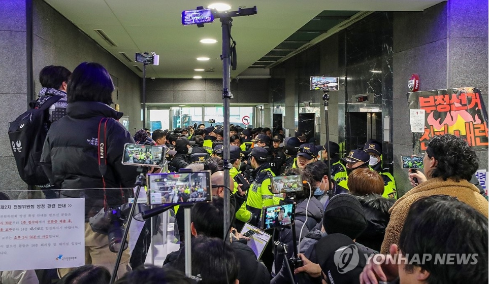 10일 국가인권위원회을 난입, 점거한 尹극우지지자들을 저지하기 위해 경찰들이 통제에 나섰다. 유튜버들이 현장 촬동도 하고 있다. [사진=연합뉴스]
