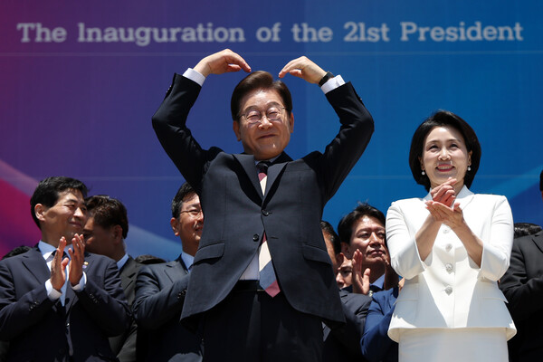 이재명 대통령이 6월 4일 서울 여의도 국회 로텐더홀에서 열린 제21대 대통령 취임선서식을 마치고 잔디광장에 모인 시민들을 향해 하트를 만들어 보이고 있다. 오른쪽은 김혜경 여사. [사진=국회사진기자단]